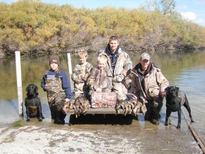 Successful duck hunt with two black Labs