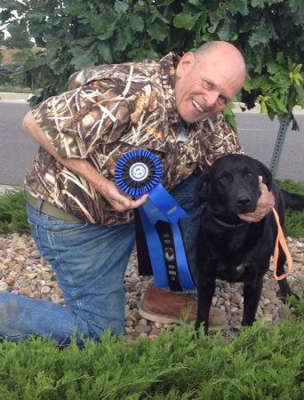 Hunter with black Labrador Retriever