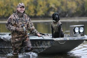 Hunter and black Lab get ready for hunting season