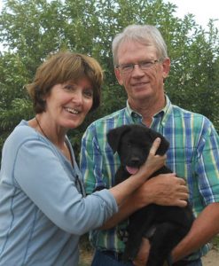 Couple happy to take home their Lab puppy