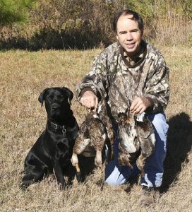 Black Lab loves retrieving ducks for his owner