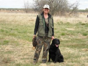 Happy owner with her black Lab after a successful day at an HRC hunt test in CO