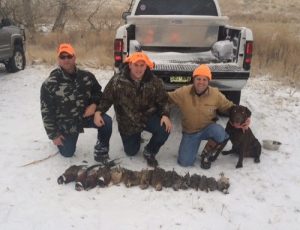 Duck hunters with their chocolate Labrador Retriever