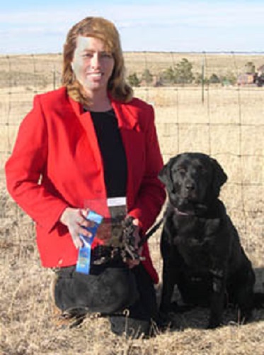 Showing off her dog show trophy and ribbons