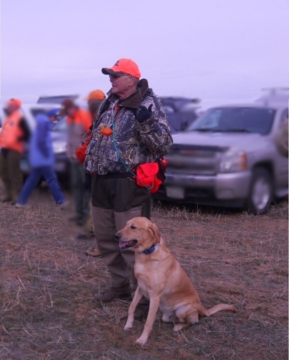 A hunter and his yellow Lab practicing for dove season